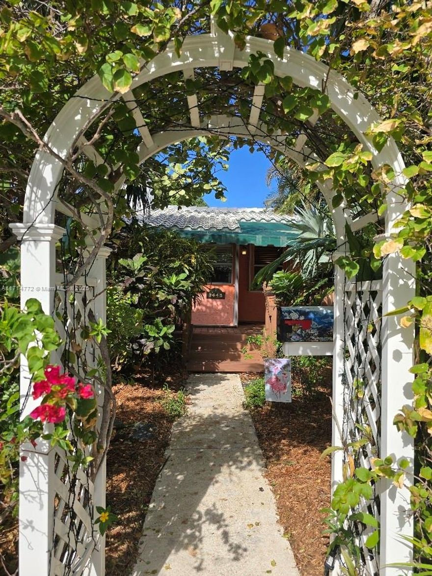 Looking for Florida charm? You’ll love this 1938 home with great character in an historic neighborhood close to downtown and the beach. Foyer entrance with window seat leads to living room featuring vaulted, wood-beam ceiling; fireplace; hardwood floors; & built-in bookcases. Updated kitchen & baths; natural gas stovetop, tankless water heater, 2024 dryer. Mature palms, easy-care 2022 deck, LED landscape lighting, sprinkler system. Screened porch leads to landscaped and fenced backyard with access to rear alley. New tile roof in 2015. Impact doors and accordion shutters; house receives highest level of insurance discounts. Walk to Hollywood ArtsPark, restaurants, festivals & parades, and nightlife, then retreat to this peaceful, stable, dog-friendly neighborhood, 3 blocks from the lake.