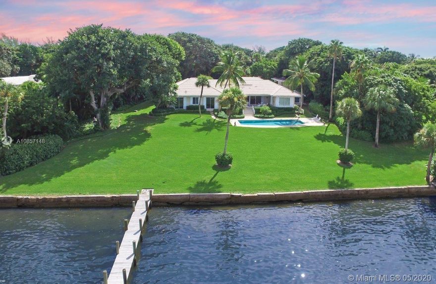 This classic Jupiter Island residence is located in the secluded Isle Ridge neighborhood, offering private beach access to all its residents. The lush 1.37± acre property is situated above the Intracoastal presenting spectacular water views and sunsets. The 4-bedroom, 4-bath main house exudes timeless elegance and includes a covered lanai, inviting pool area, a 2-car garage, a storage building and a separate 1BR/1ba guesthouse. Its green lawn sweeps down to 185± feet of shoreline where the private dock is at your convenience. This very attractive property, set amid ancient trees and lush foliage, can be the perfect setting for your Jupiter Island haven.