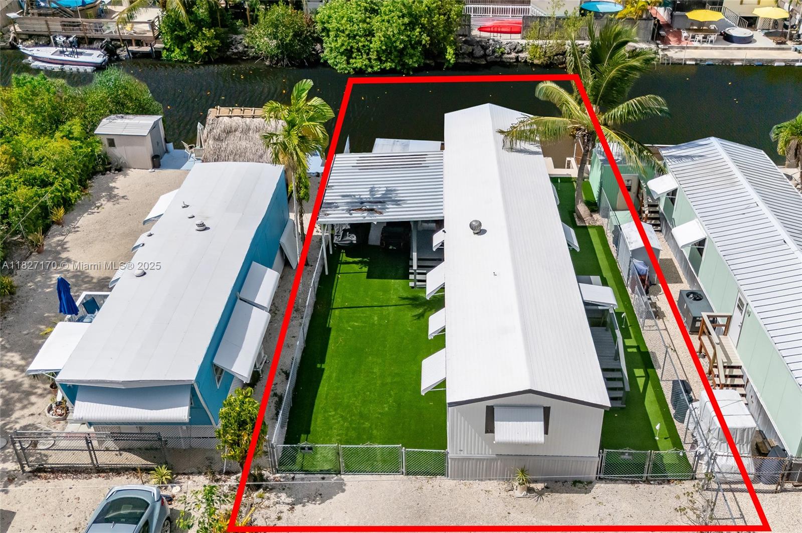 Fully remodeled waterfront gem in Key Largo! This single-wide features a brand-new kitchen, central AC and mini split, laminate flooring throughout, washer/dryer hookup, and a fully fenced turf yard with a private putting green. Enjoy a back porch, your own dock, and easy ocean access. Excellent opportunity in a great neighborhood—perfect for weekend getaways or full-time living just off the stretch and in an ideal central Key Largo location near all major restaurants. The community also has its private ramp for residents. NO HOA!
