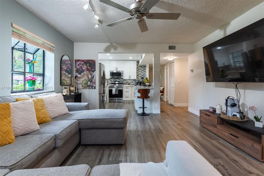 Must-See Opportunity! Discover this beautifully renovated 2 bed, 2 bath corner unit in the gated Bonaire at Woodmont. With nearly 1,500 sq ft, this rare first-floor gem offers spacious luxury with fresh paint, new vinyl floors, spa-inspired bathrooms, and a stunning modern kitchen featuring stainless steel appliances and custom cabinetry. Enjoy both front and back screened patios for peaceful indoor-outdoor living. Natural light pours into every room. Steps to Woodmont Country Club, minutes from Sawgrass Mills, dining hotspots, and A-rated schools. Whether you're looking for your forever home, a seasonal retreat, or the perfect low-maintenance lifestyle upgrade—this is it. Truly turn-key, in one of Tamarac’s most desirable communities.