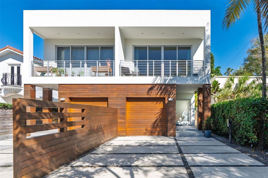 Discover elevated living in the heart of Coconut Grove. Built in 2017 & set on one of the highest natural elevation points in highly coveted Center Grove, this contemporary residence blends privacy, design, & quality craftsmanship. The 3BD/3.5BA home offers 2,802 SF of sophisticated interior space w/ thoughtfully curated finishes, modern architecture, & exceptional attention to detail throughout. Upstairs Den can be converted into 4BD. Home features 10ft ceilings, designer 48”x48” large format porcelain tile floors, a striking glass-sided wood-staircase, expansive glass doors that flood the living room w/ natural light, & a spacious dining area ideal for entertaining. The chef’s kitchen is beautifully appointed w/custom wood cabinetry & a generous center island that anchors the space w/ both, style & function, equipped w/ Miele & Thermador appliances. The primary suite serves as a serene retreat, complete w/oversized glass windows, dual vanities, & a spa-inspired bath w/ a soaking tub. Gated wood entry enhances privacy & exclusivity, while the outdoor patio provides a tranquil setting for intimate gatherings or quiet evenings at home. Extra features include a backyard studio shed, 16.4kWh SunPower solar panels, garage storage lift, drop down projector screen, pet-friendly turf, 2 Tesla chargers, Lutron smart lighting, an 8ft solid core doors with SOSS hidden hinges, & more. A rare opportunity to own a unique residence in one of Miami’s most prestigious neighborhoods.
