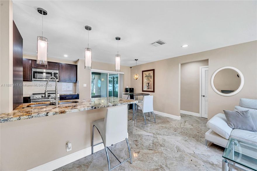 Beautifully remodeled 2-bedroom, 2-bath home with 1-car garage located in the desirable Mainlands of Tamarac Lakes. This move-in ready home features elegant marble flooring throughout, a spacious open-concept kitchen with granite countertops, stainless steel appliances, and recessed lighting. Both bathrooms have been tastefully updated with marble finishes, shower panels, and Bluetooth fan lighting. Impact windows, doors, and sliders provide peace of mind.

Additional highlights include a large interior laundry/utility room, freshly painted interior, and a generous screened-in porch overlooking the landscaped yard—perfect for relaxing or entertaining. The community offers a clubhouse, pool, and sprinkler/irrigation services included in the HOA.