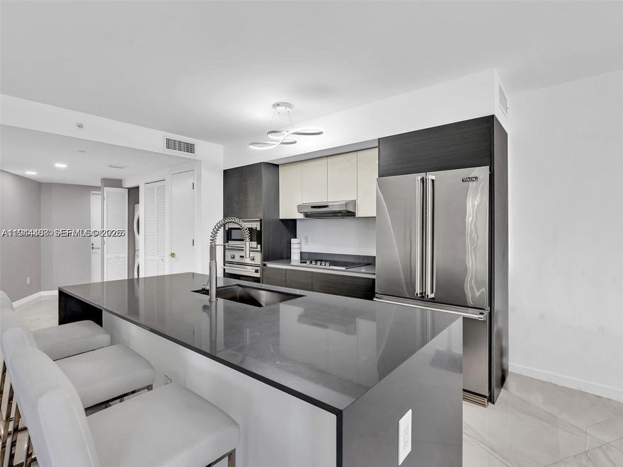 Experience exclusive island living in this one-of-a-kind lanai corner residence. This spacious unit features sleek European cabinetry, quartz countertops, and top-of-the-line Viking appliances. Bathrooms are finished with elegant marble flooring, includes a ground-level storage space and 2 assigned parking. Massive 479sf private balcony. Located in The O Residences, a boutique waterfront condominium offering resort-style amenities such as a sunset-facing pool and hot tub, cascading waterfall, spa with sauna and steam room, fitness center, bay front water deck with kayaking and paddle boarding, and an outdoor summer kitchen with barbecue. Just a short walk from the beach and world-renowned Bal Harbor Shops. Short-term rentals allowed.Seller paid assessment in full.