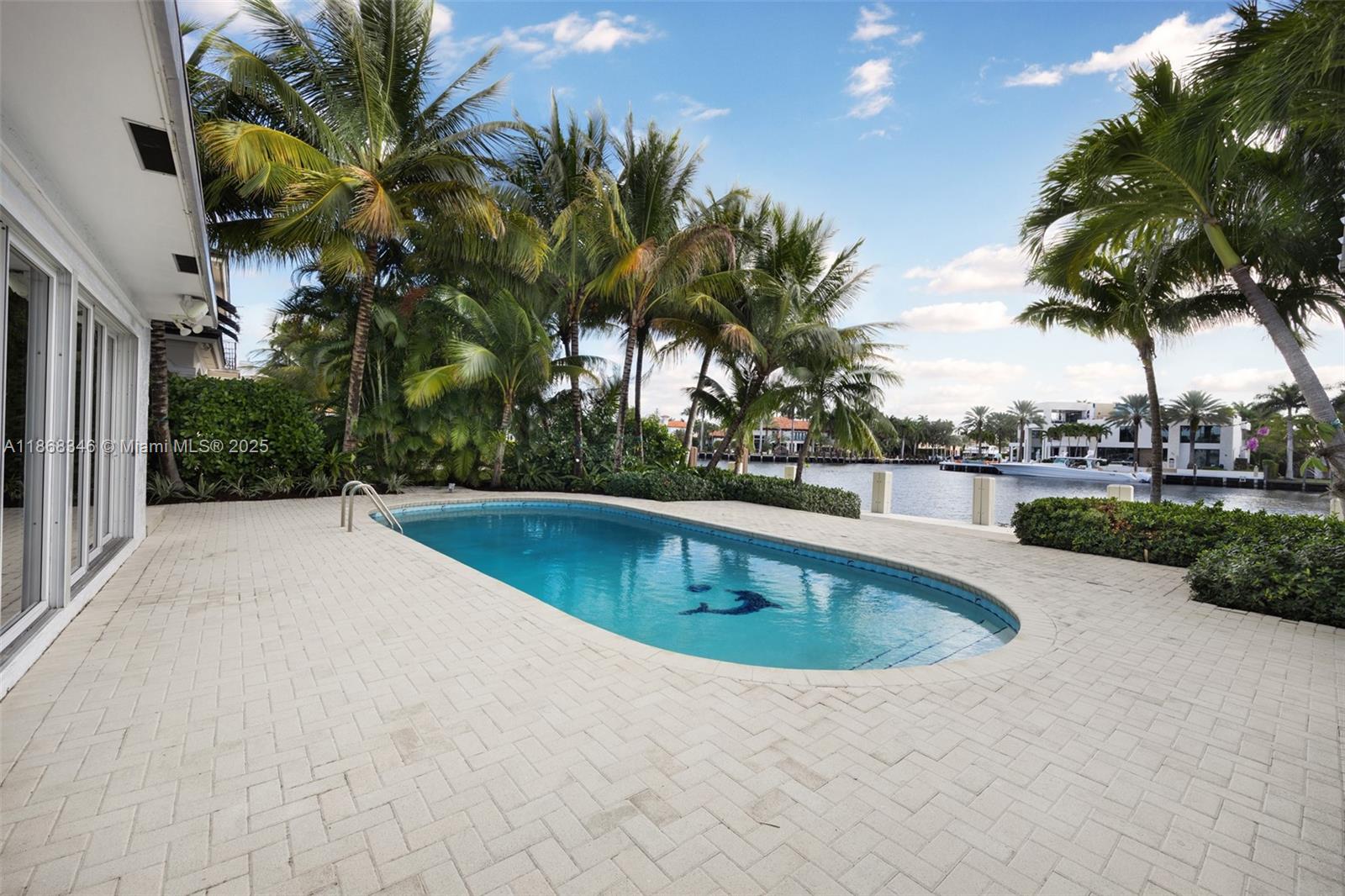 Located on gated Sunrise Key, this renovated waterfront pool home offers expansive views across the Rio Barcelona Canal (widest in Fort Lauderdale) and beautiful sunsets. The split floor plan four bedroom/three bath home offers privacy and space for everyone. 100 feet of deep-water dockage with no-fixed bridge ocean access can accommodate vessels with draft up to 10 feet. Sunrise Key is a gated all-waterfront neighborhood with 64 luxury homes offering easy access to the beach, Las Olas, and downtown Fort Lauderdale.