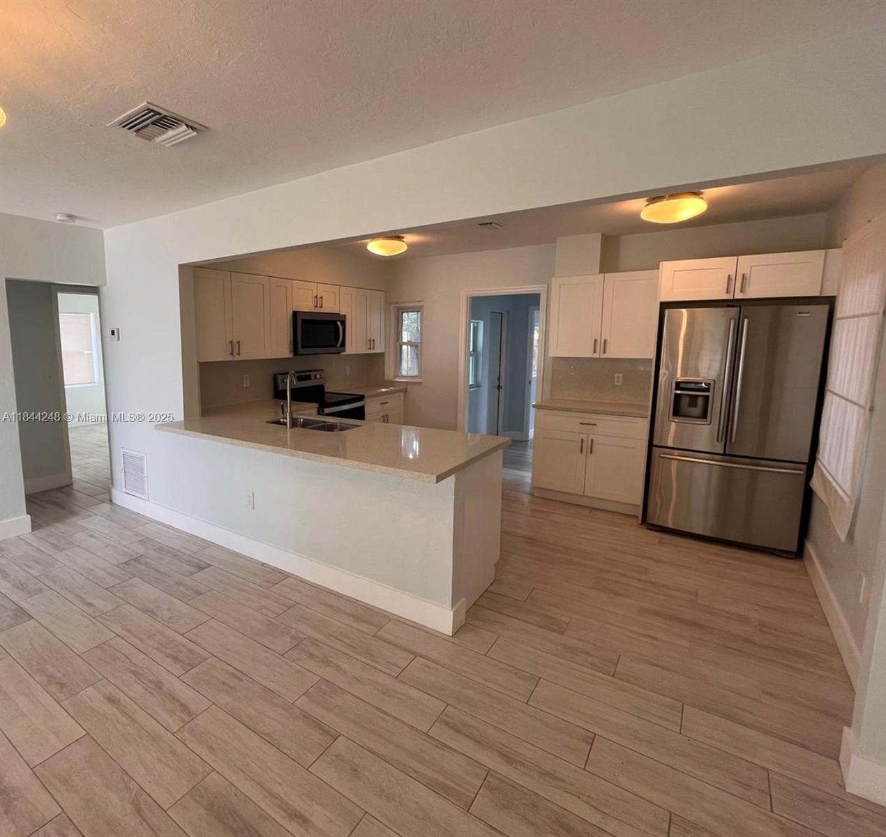 New on Market! Ample and bright home in highly desirable West Buena Vista neighborhood. Great floorpan offers a nice open kitchen with working breakfast counter big enough to sit 4 people, private master bedroom with private side entrance and fully remodeled kitchen, bathrooms and floors. Home can be divided as 2/1 and 1/1 with 2 independent entrances. Property is fully fenced for privacy with space to park 1 car inside and street parking for guests. Huge Yard perfect for families and entertaining. Ceramic tile floors throughout, central A/C, ample bedroom spaces and stainless steel appliances. Minutes from Wynwood, Midtown Miami and Design District and a short drive to Miami Beach, I-95 and airport.
