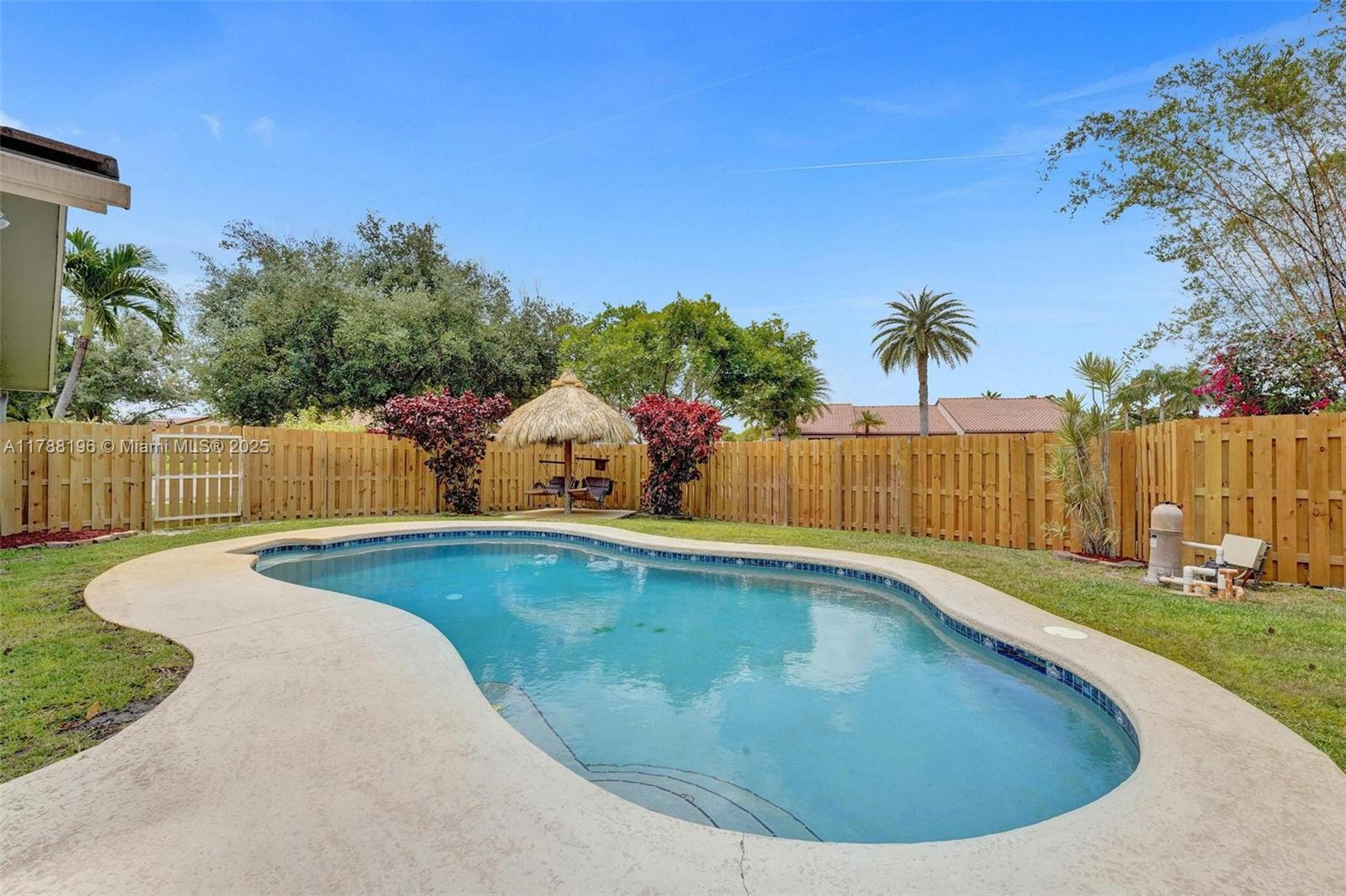NEW IMPROVED PRICE! **NO MORE ELECTRIC BILLS! **Home runs on solar only! Come home to this entertainer's large 4 bedroom 2 bathroom dream home.Featuring a large pool area ,tiki hut,& fire pit area perfect for entertaining! Relax in the length of the home screened-in porch as an extra space and enjoy the large separate side yard for your pets, or even park a boat or RV! NO HOA fees. Owners just added a brand new wood privacy fence enclosing the yard. HURRICANE IMPACT WINDOWS & DOORS! SOLAR PANELS! NO HIGH ELECTRIC BILLS! Inside is an impeccably maintained split floor plan with newly added tile throughout that is designed for comfort and style. This home is a must-see! A+ Schools. Walking distance to Forest Lake Park with pickle ball & tennis courts, tot lot, basketball and walking trail.