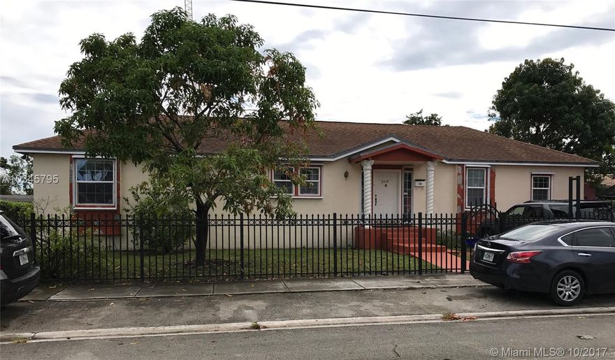 Beautifully renovated 4 bedroom 2 bath home offering wide open living, dining, and kitchen area centered in a split floor plan. Features include: large kitchen with snack counter and island, master with dual sinks,separate tub, and shower, laminated wood flooring throughout most of the home. Hurricane shutters, alarm, and decorative iron fence for privacy and security. Newer construction, 2002.