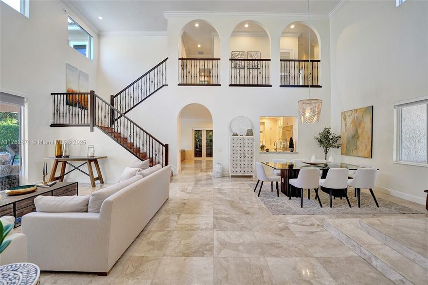 Experience luxury in this elegantly renovated golf-front estate in Weston Hills CC. Nestled on private cul-de-sac lot, this 6-bed, 4-bath home offers NEW 2025 ROOF being installed, FULL-IMPACT windows, and lush landscaping. Remodeled contemporary kitchen with grand marble island, custom marble countertops, wine fridge and double ovens. Marble floors flow through first level and new wood flooring upstairs. Primary suite on first floor offers sitting area, marble bath, and adjacent office. Upstairs, spacious playroom opens to private balcony with golf views. Outdoors, enjoy heated saltwater pool, fenced yard, and screened-in side yard. Circular paver driveway leads to 3-car garage, completing this spectacular home. Don’t miss this move-in-ready masterpiece in Weston’s most coveted community!