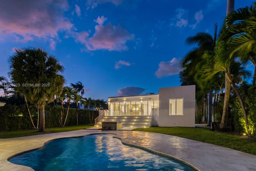 Your private oasis—where modern luxury meets serene waterfront living in one of Miami’s most desirable enclaves near Davis Harbor. This exceptional estate showcases 75 feet of prime water frontage and a 50-foot private dock with no fixed bridges, offering direct ocean access to Biscayne Bay—an unparalleled advantage for boating enthusiasts and yacht owners alike. Designed with a refined luxury presence, this residence is ideal for both elevated entertaining and everyday comfort. Enjoy a private beach and a resort-style heated saltwater pool with a tranquil jacuzzi, all surrounded by lush, professionally landscaped grounds. The expansive travertine deck and top-of-the-line Fisher & Paykel outdoor kitchen create a seamless indoor-outdoor lifestyle, perfect for upscale alfresco dining and hosting. A gated entry ensures privacy and exclusivity, while the detached guest house—currently outfitted as a private gym—offers flexibility as a guest suite, executive office, or maid/nanny quarters. Built in 2015, this turnkey smart home delivers modern architecture, high-end finishes, and the ultimate Miami waterfront lifestyle. A rare opportunity for the discerning buyer seeking luxury, privacy, and direct ocean access—minutes from world-class dining, beaches, and vibrant city life.
