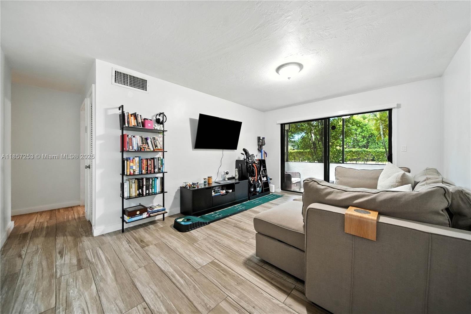 Be ready to feel right at Home with this cozy updated corn unit condo in Palmetto Bay, featuring wood-look porcelain tiles, impact windows & Sliding Glass door, wood shaker style kitchen cabinets with granite countertops & stainless steel appliances. The large bedroom offers a spacious closet and ample space. The bathroom tiles throughout the walls, a glass enclosed shower and linen closet. Relax on the screened-in covered patio with peaceful garden views. Prime location just minutes from The Falls, shopping centers, dining, and more. Perfect for comfort, style, and convenience!