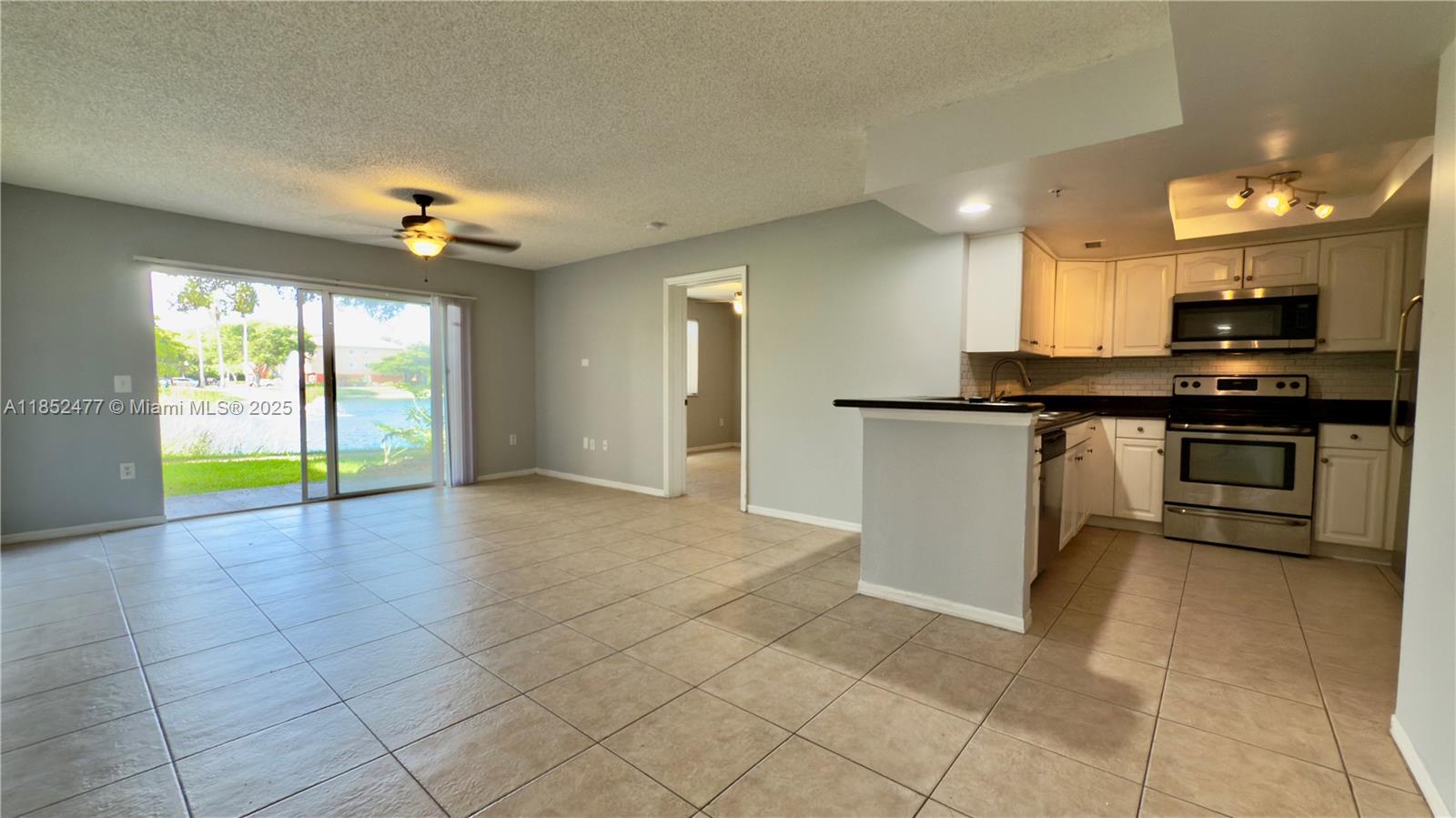 Spacious and bright 2-bedroom, 2-bath unit with a beautiful lake and fountain view from the private patio. Located just steps from the pool with easy access and first-floor convenience. The unit features two closets per bedroom, a large private garage, full set of appliances, and in-unit washer and dryer. Located in the gated community of Grand Isles, offering resort-style amenities. Move-in ready.
Please use ShowingTime for instructions — Lockbox, no appointment needed.