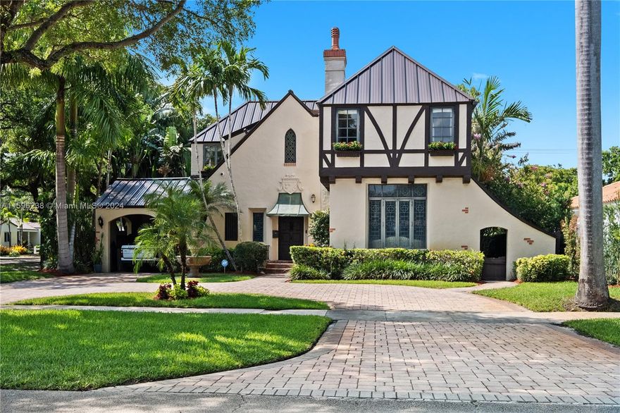 LIVING SQ. FEET PER APPRAISAL 3,265  LANDMARK MIAMI SHORES HOME BUILT IN 1935 BY AND FOR THE RENUART LUMBER FAMILY.  OLD WORLD CHARM WITH TOP-NOTCH CRAFTMANSHIP THAT IS HARD TO MATCH TODAY.  CBS CONSTRUCTION, THIS 2-STORY TUDOR STYLE IS A 10 OUT OF 10 WHEN IT COMES TO CURB APPEAL.  BEAUTIFUL ENTRY FOYER WITH ELEGANT OPEN STAIRCASE, THEN ENTER THE GRAND FORMAL LIVING ROOM WITH SOARING CEILINGS, INCREDIBLE WOODWORK AND HUGE CUSTOM WOOD-BURNING FIREPLACE.  BIG DINING ROOM, LIBRARY/DEN, AND FAMILY ROOM.  2 FULL BATHS ON THE FIRST FLOOR, 3 BEDROOMS AND 2.5 BATHS ON THE SECOND LEVEL.  OFFICE, NANNY OR GUEST ROOM, INSIDE LAUNDRY ROOM.   IMPACT WINDOWS, NEW METAL ROOF, UPDATED PLUMBING AND ELECTRIC, ONE CAR CARPORT.  FENCED CORNER LOT WITH HEATED POOL, PATIO AND GRASSY AREA.
