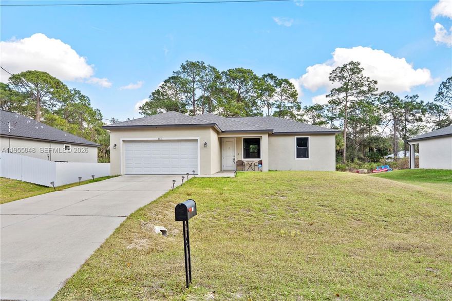 This beautiful 3-bedroom, 2-bathroom home, built in 2022, is located in the growing community of LaBelle, Florida, and sits on a spacious ¼-acre lot with a 2-car garage. Designed with comfort and style in mind, the property features an open-concept kitchen with elegant high-gloss white cabinetry, stainless steel appliances, and granite countertops, seamlessly flowing into the main living areas. The home offers waterproof laminate flooring throughout, thoughtfully selected to complement the granite surfaces and neutral wall colors. Both bathrooms are fully tiled and feature modern vanities with granite countertops and refined finishes. High ceilings throughout the property enhance the sense of space and natural light, while impact-resistant windows and doors provide added security and energy efficiency. As a newer construction, this home offers long-life systems and the benefit of more affordable property insurance. Additional features include a complete ADT security system with cameras and door and window alarms, washer and dryer, and partial furnishings, including a living room set, dining table, sofa, and more—all included in the sale. This move-in-ready home combines modern design, quality construction, and valuable upgrades, making it an excellent opportunity for homeowners or investors alike.