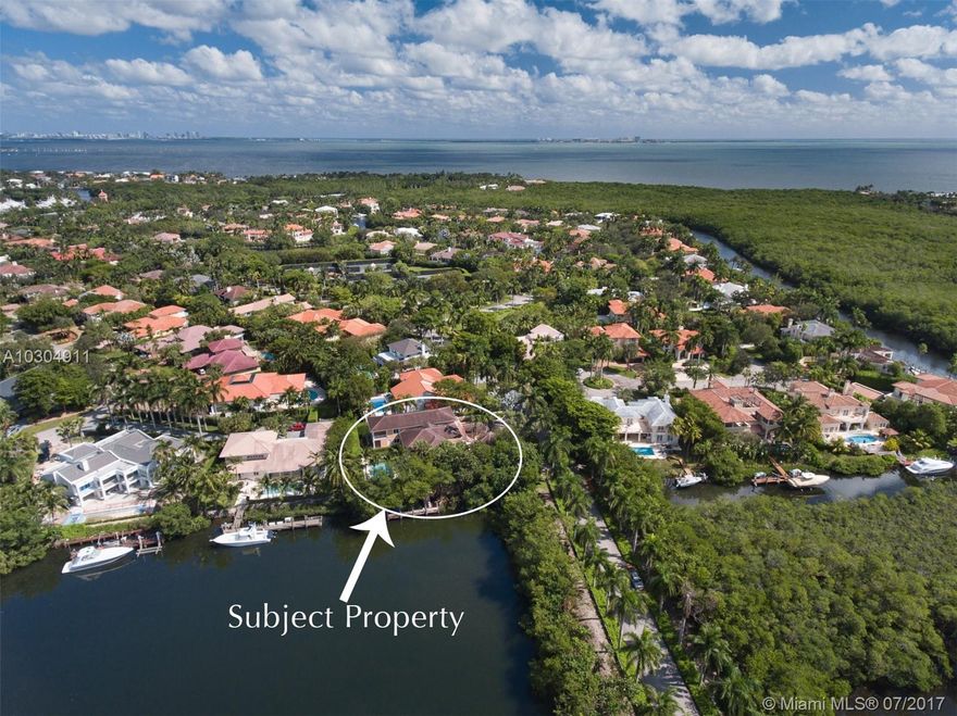 Exquisite Cocoplum  home features 6 bedrooms with en-suite baths and wood finished closets. Large formal living room with volume ceilings, formal dining room overlooking the gardens, spacious family room with mahogany built-ins and views of the water and swimming pool.  Second floor master suite and sitting area have lovely water views and a private terrace. Private dock with one bridge access to the bay, full house generator, elevator, and oversized 2 car garage complete this special offering.New roof was installed in 2019.