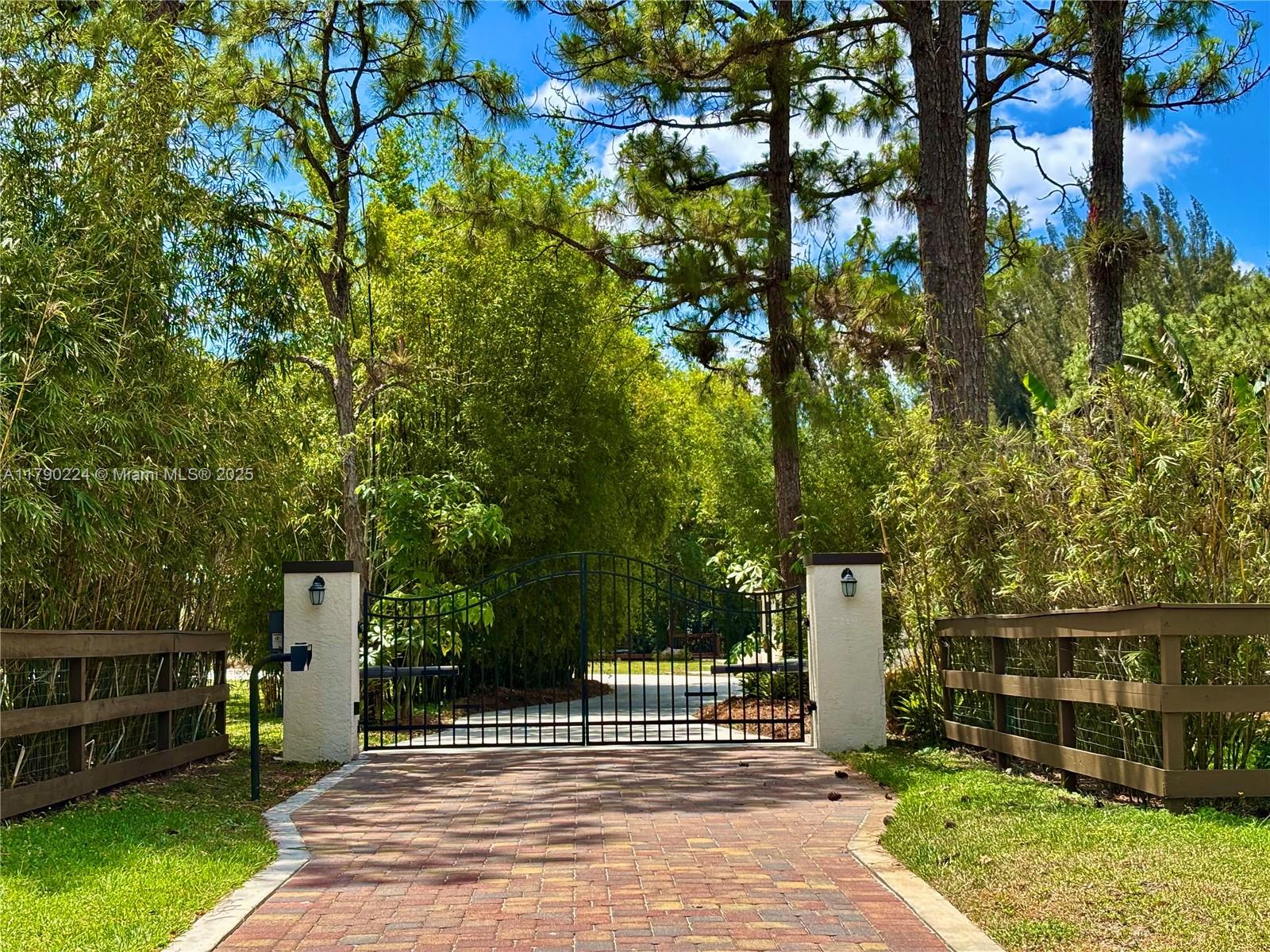 Discover a rare 5-acre luxury estate in West Palm Beach featuring four detached structures: a fully renovated main house and guest house, an air-conditioned workshop, and a four-car garage. The main residence includes natural stone marble, travertine, and genuine hardwood flooring, a chef’s kitchen with high-end appliances, and spa-like marble bathrooms. The gated, fully fenced property offers a circular driveway, pond, pool, orchard, garden, and approximately two acres of pasture/produce land. Utilities include 4 wells, 2 septic tanks, an in-ground propane tank, a water treatment and softener system, and an automatic sprinkler system. Located just minutes from downtown, Palm Beach Island, and the airport, with easy access to major highways. Private, peaceful, and truly one-of-a-kind.