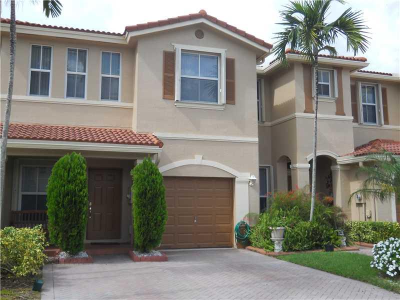 Immaculate, well-kept waterfront Mediterranean-style 2/2.5 townhouse in a great location bordering Weston/Sunrise (Weston schools). Spacious unit features beautiful lake view, formal living room with volume ceiling, formal dining room plus family room, ac cordion shutters, rain gutters, extended screened tiled patio, neutral one-year old carpeting, A/C two years young. 1-car garage plus parking for 4 cars. Very well-kept community (Recently painted)! Not a foreclosure or short sale. Hurry! Will not last!