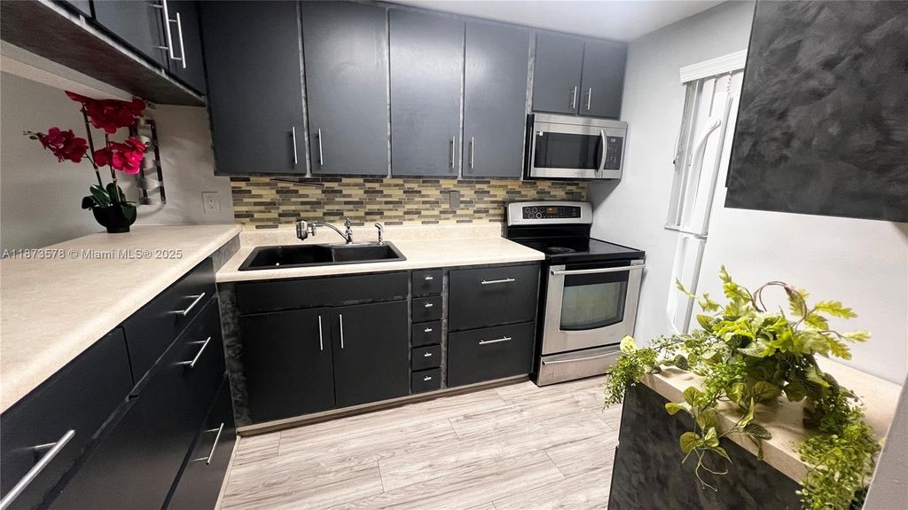 Photo of 7610 Stirling Rd #103B, Davie, FL 33024 (MLS # A11873578)