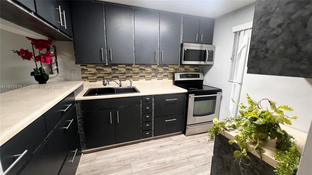 Photo of 7610 Stirling Rd #103B, Davie, FL 33024 (MLS # A11873578)