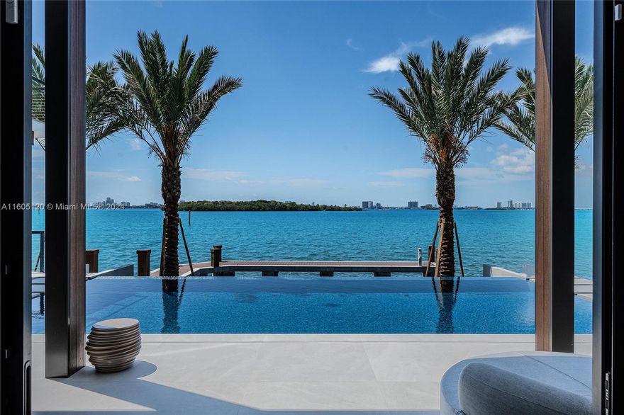 Designed by Portuondo Perotti, this 12,633 SF mansion epitomizes luxury.Boasting 102 FT on the water it offers stunning open bay views and downtown Miami skylines.The sleek exterior combines glass, stone, and wood.Inside, custom Italian millwork and a grand wall of glass frames the breathtaking bay views.The first floor showcases 12.5-foot ceilings and spacious living areas stretching across an impressive 80-foot span!It includes a family and chef’s kitchen with top-tier appliances, six bedrooms, 7.5 bathrooms, an office, a gym, and an elevator. Additional amenities include a 539-bottle wine room, top-of-the-line lighting, and a Lutron Homeworks system.Outdoor features include a knife-edge infinity pool, summer kitchen, and private dock.This estate offers unparalleled comfort and elegance.