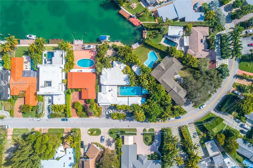 Rare on market! Live The Surfside Dream On Biscaya Dr! Also Known As The Isle Of Biscaya, You Will Find a Feeling Of Peace And Tranquility. With A Consistent Ocean Breeze Directly Hitting The Rear Of The Home, It Is Like Living On The Beach But With A Large Dock. This Home Is A Large Compound Under Newly Replaced Roof (7500+/- SqFt). The Front Wing Features One Bedroom, One Bathroom, Kitchen, And Living/Dining Room. The Second Wing, Above Two Car Garage, Has Two Bedrooms and One Bathroom. There is a 50x20 Pool Separating the Front And Rear. The Rear Wing Features A Large Master Suite With Balcony, Four Bedrooms With Two Bathrooms, Half Bathroom, Large Kitchen, Living, Formal Dining, Bar, Front/Rear Screened Porches, And New Rear Deck. Detached Rear Office/Bedroom. 80+Ft Of Water Frontage.