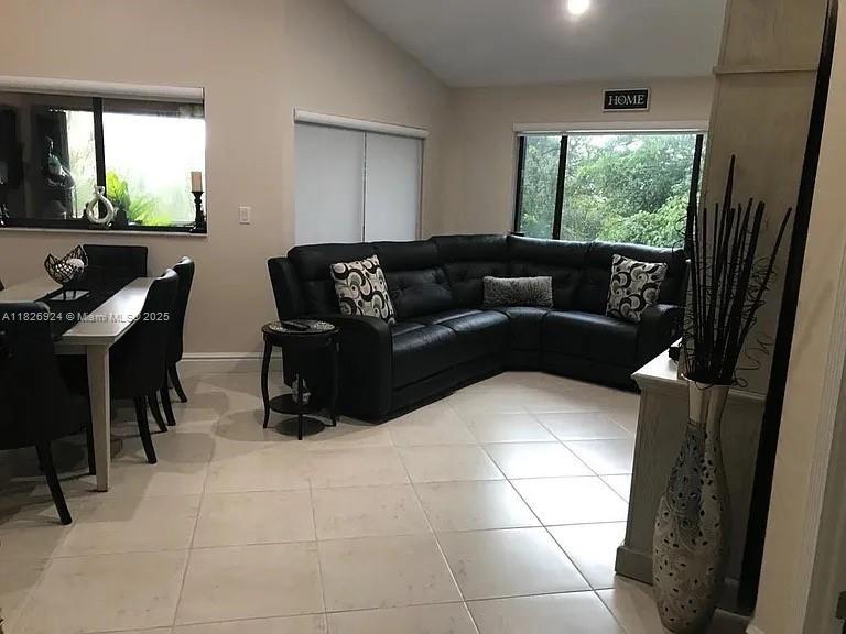 Welcome to your new home in the heart of Miami Lakes! This beautifully maintained 2-bedroom, 2-bath condo is located in the highly desirable Celebration Point community. Situated on the top floor, this spacious unit features vaulted ceilings, abundant natural light, and a serene lakefront view from the private balcony-perfect for relaxing or entertaining. The open-concept layout includes a large living area, an updated kitchen with stainless steel appliances, and an in-unit washer/dryer. The master bedroom offers an en-suite bath and ample closet space. Enjoy tranquil walks around the lake, a refreshing dip in the community pool, and lush, tree-lined surroundings. The unit has impact windows and doors plus accordion shutters for extra safety. It's a true Miami Lakes gem.