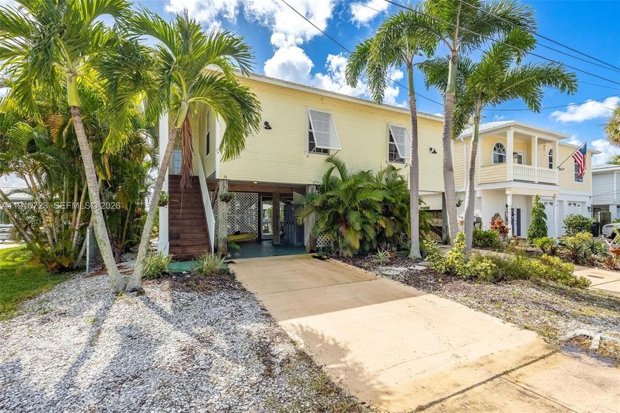 CALL MATLACHA HOME OR USE AS A VACATION RENTAL WITH NO WATER-INTRUSION WORRIES—CURRENTLY INCOME-PRODUCING This elevated 2-bedroom, 2-bath waterfront retreat offers island living at its best with hurricane-impact windows, an open kitchen-to-great-room layout, and stunning water views from nearly every room. Both bedrooms are spacious, and a flex space off the great room adds room for guests or a home office. Enjoy morning coffee and wildlife watching from the screened lanai, plus ground-level storage, a second patio, and a newer dock for boating. With minimal Ian damage and no known water intrusion, this is the best-priced elevated home in Matlacha and a move-in-ready paradise.