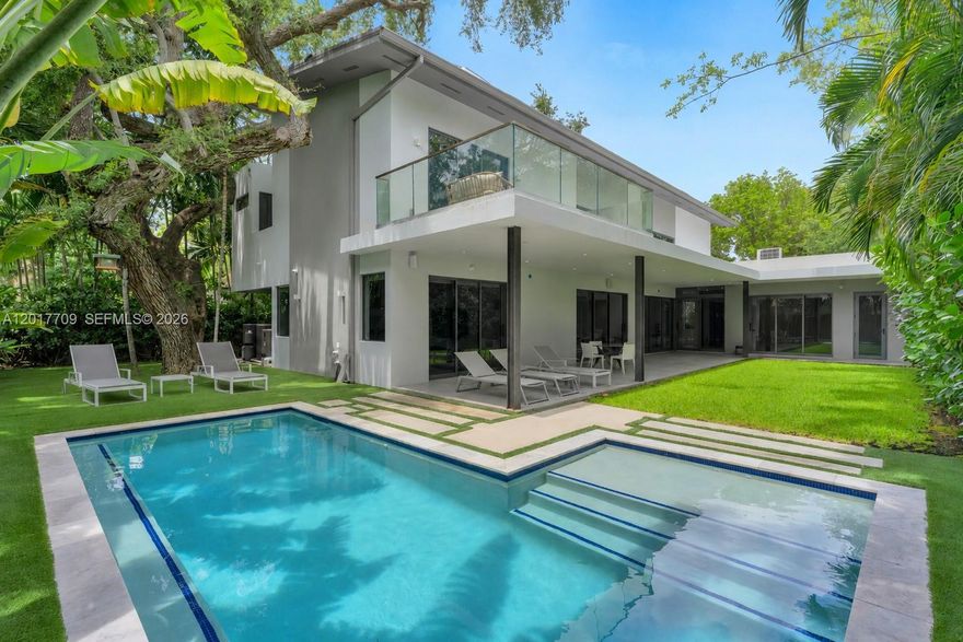 Nestled in the exclusive enclave of North Coconut Grove in BAY HEIGHTS, this exceptional new modern construction redefines luxury living with striking architectural design and refined contemporary finishes throughout. A dramatic double-height entry and soaring ceilings create an impressive sense of scale, while walls of glass flood the residence with natural light. Offering 5 spacious bedroom suites, a dedicated staff/maids room, 6 full baths, and a powder room, the thoughtfully designed layout blends elegance with functionality. Designed for both grand entertaining and everyday living, the home features expansive living spaces including a family room, second-floor loft/lounge area, oversized covered terraces, and seamless indoor-outdoor integration surrounding the resort-style pool. Sophisticated Porcelanosa concrete flooring flows throughout, complemented by a bespoke Italian kitchen by SCIC Italia equipped with premium Miele appliances. The luxurious primary suite offers a spa-inspired bath complete with a private outdoor shower immersed in lush tropical surroundings. Additional highlights include custom walk-in closets, lacquer-finish interior doors, a magnificent wood pivot entry door, LED lighting throughout, generous storage, pantry, laundry room, and impeccable attention to detail throughout this exceptional residence. Close proximity to Brickell & Downtown Miami just 7 minutes away, and only 15 minutes to Miami International Airport.