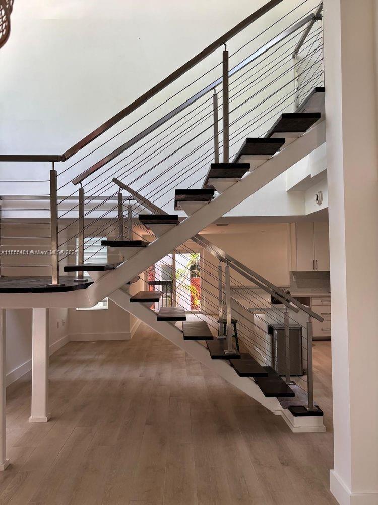 This reimagined California contemporary offers 4 bedrooms, 2.5 baths, and a versatile layout with three bedrooms upstairs and a guest suite on the main level. Expansive windows highlight vaulted, wood-beamed ceilings, open living and dining areas, and a striking floating staircase. Updates include impact windows/doors, a sleek chef’s kitchen, new flooring, spa-inspired primary bath, and custom walk-in closet. Detached parking for 2–3 vehicles. Prime location near CocoWalk, cafés, boutiques, parks, and minutes from Brickell, Coral Gables, and Key Biscayne. Enjoy tranquil Grove living with city convenience. Credit check, police report, and 24-hr notice required.