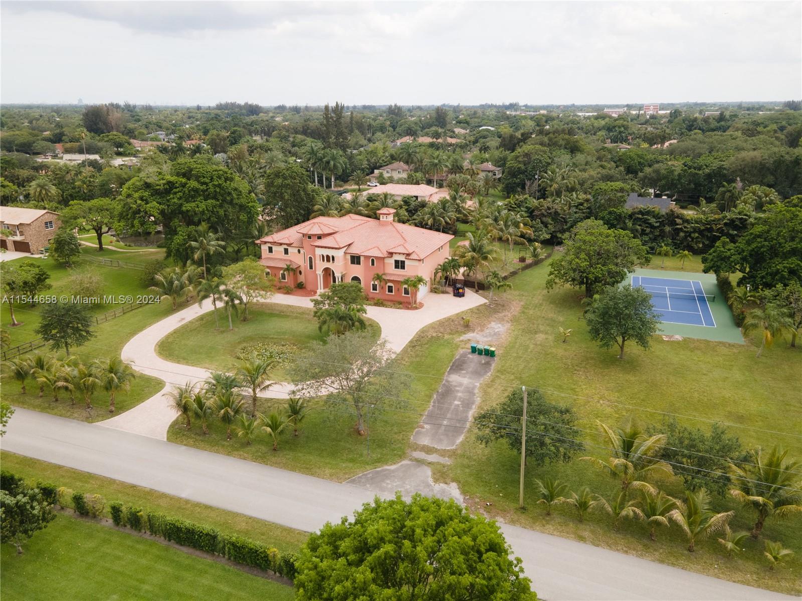 Available - Large estate home on one of the largest lots in the Plantation Acres, 2.36 acres. This six bedroom, six and one half baths two story home with a two story entry way, has a chef's kitchen with gas appliances and an eat-in area, formal dining room, theatre room with a wet bar, large master suite with his/her closets, formal living area with a wet bar, separate laundry area, a balcony overlooking the pool and two, two car garages. The home also has an area for an elevator. The exterior includes a large pool with a jacuzzi, a summer kitchen, tennis court with a basketball court included and a large circular drive leading up the home. No HOA for this property. Conveniently located near shopping, restaurants, schools and easy access to major highways and FTL airport.