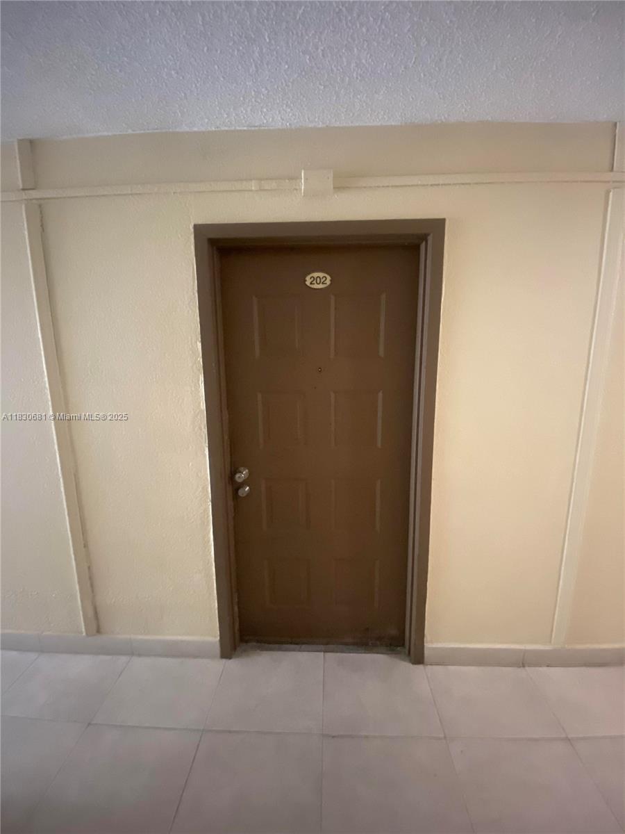 Beautiful and move-in ready 2-bedroom, 1-bathroom unit located in the sought-after community of Coral Gate East. The apartment features a freshly painted interior, tile floors. The unit is nestled in a secure community with 24/7 security patrol, and residents have access to amenities including a gym, community pool, and laundry facilities. Conveniently located near major highways, hospitals, schools, and shopping centers. Easy to show!
