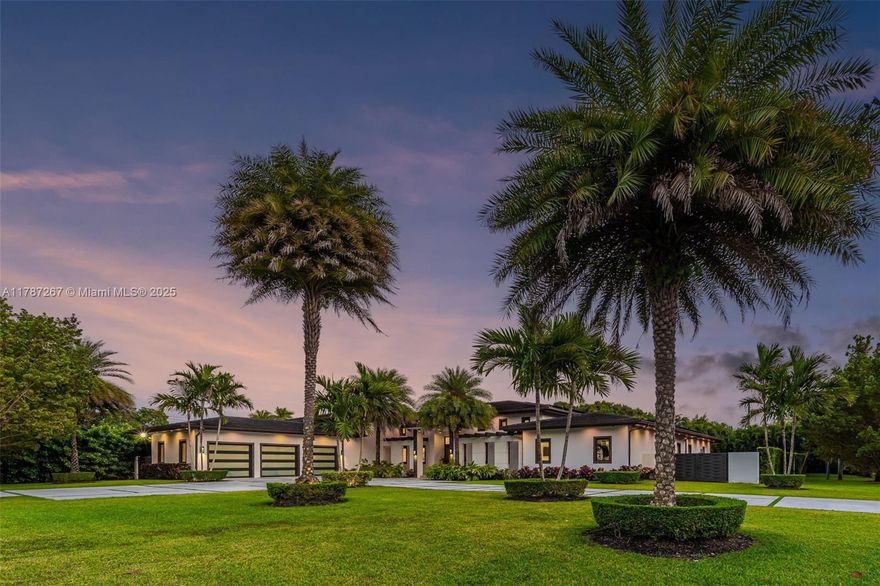 Sleek and stunning 6BD/7BA smart home on a lush 30,000 sf lot in prime Kendall. Soaring ceilings, porcelain floors, and a sunlit open layout set the tone. Gourmet kitchen with striking wine wall, cork accent, and private bar. Lavish primary suite with spa bath and dual closets.  Four junior suites with luxe en-suites. Resort-style backyard with 40x16 heated pool, jacuzzi, fountains, turf throughout, pergola, putting green, and summer kitchen with live moss wall. Full bath attached to outdoor structure. Casement impact windows, solar panels with credits, 3-car garage, whole-house generator. Near elite schools, The Falls and Briar Bay Park.