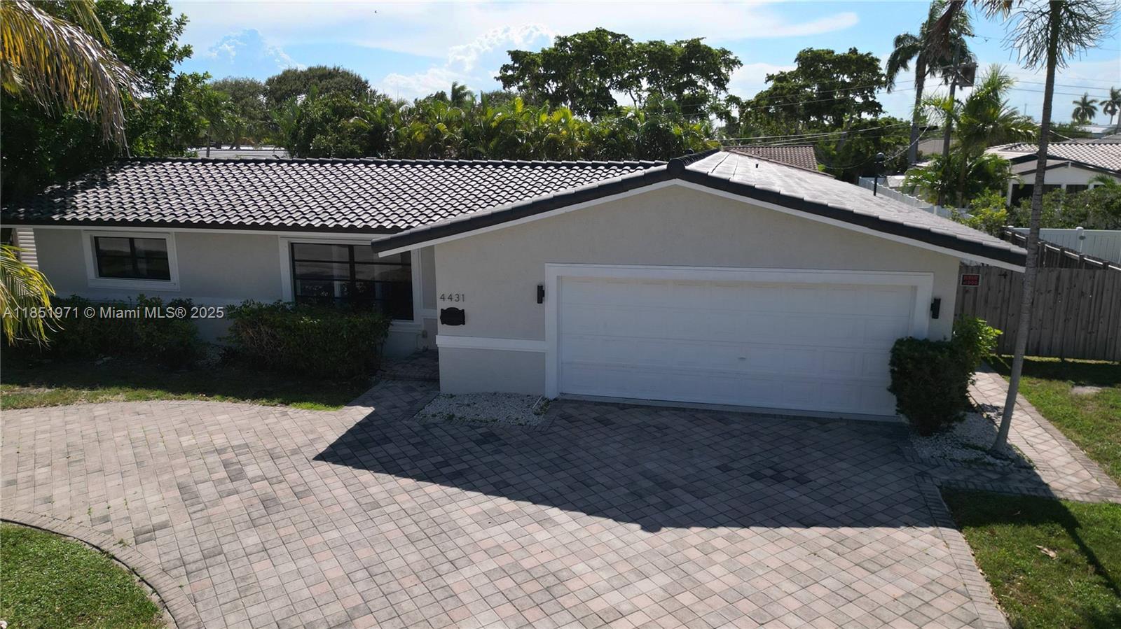 Best-priced opportunity in Lighthouse Point’s prestigious Venetian Isles neighborhood. This 4-bed, 3-bath coastal-style home offers a functional split floor plan with a spacious 2,053 SF interior. On one side of the home, the primary suite features a cabana bath with direct access to the patio. The other wing has three additional bedrooms, two of which offer private exits, and one that connects to a full bath accessible to the garage and backyard. A kitchen opens to a generous family room, perfect for entertaining or relaxing. 9,000 SF lot features a large fenced yard, space for a pool, outdoor kitchen, or grill station. A big circular driveway, two central A/C units, and the roof was recently sealed and painted — ready for you to move in and transform it into your dream home.