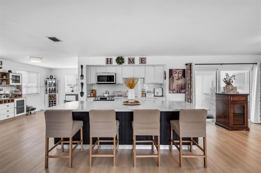 Welcome to this fully renovated 3-bedroom, 2-bath pool home offering over 2,000 sq. ft. of modern living space. Situated on a generous lot in a quiet neighborhood, this turnkey property blends contemporary upgrades with timeless comfort. Recent 2024 renovations include: aluminum roof, impact windows and doors, Lennox 5-ton A/C with new ductwork, fully updated plumbing, modern gutters, brand-new kitchen with sleek finishes, and new flooring throughout. Open-concept layout features bright and spacious living and dining areas that flow seamlessly into the kitchen and out to the pool and patio—ideal for entertaining or family gatherings. Yard offers a pool and a large lot, ready to be transformed. Move-in ready with high-end finishes, this home is designed for lasting comfort and style