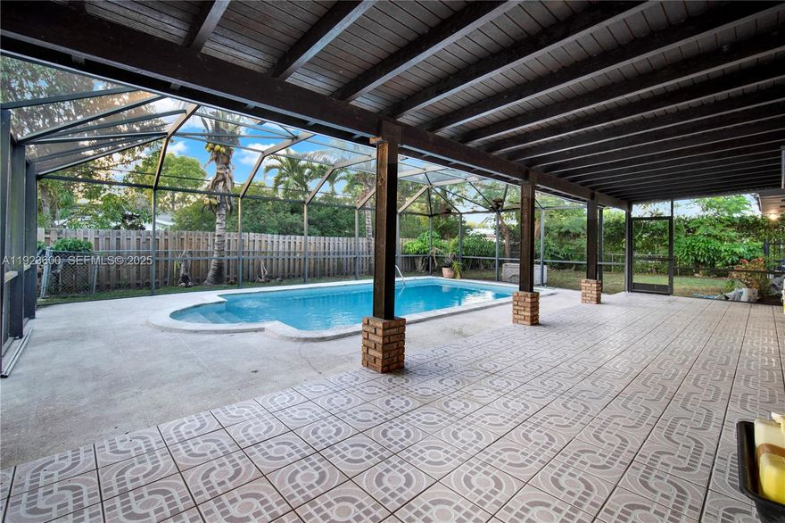 Step into the extraordinary potential of this spacious 4-bedroom, 2-bathroom, 2-car garage home on a quiet street, perfectly nestled on an expansive 1/3 acre lot. This is not just a house; it's a 2,529 square foot blank canvas offering the rare opportunity to craft the custom residence you've always envisioned. Step outside to what could become your everyday retreat! The backyard is designed for year-round enjoyment, boasting a fabulous screened-in pool perfect for swimming and relaxation without the bother of bugs. The adjoining covered patio combo provides a shaded haven for dining, entertaining, or simply unwinding after a long day. You don't want to miss out on this rarely available property in The Falls area that offers world class dining, shopping, schools, and parks within minutes of your future home. Seller financing is available, call to schedule your private tour now.