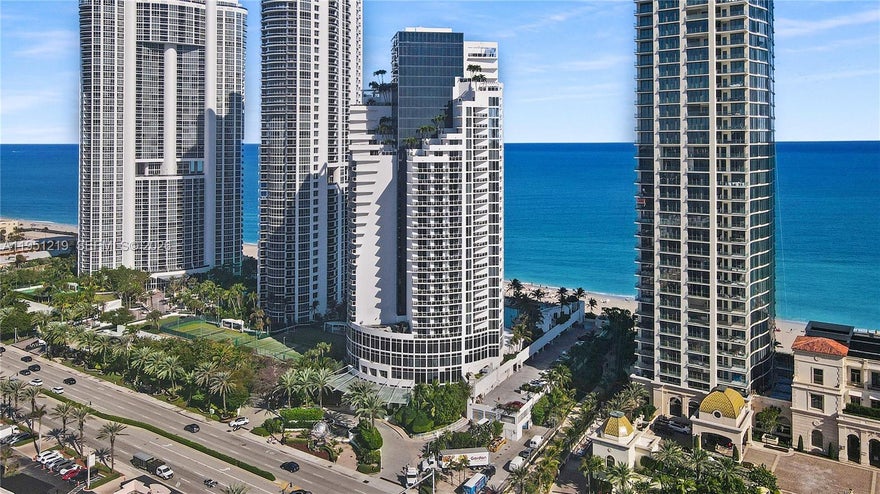 Oceanfront condo with over 1,021 sq ft of interior space and a private balcony!  Offering sweeping views. This fully furnished unit features a complete kitchen, expansive living and dining area, elegant bathroom, in-unit washer and dryer, walk-in closet, dedicated owner’s closet with lock, and a built-in workstation—ideal for both leisure and business stays. Enjoy world-class resort-style amenities, including direct beach access with service, oceanfront dining, full-service spa, state-of-the-art fitness center, tennis courts, two resort pools, valet parking, and 24-hour security. Currently part of the hotel program, this unit generates steady income and offers flexible personal use. A premier beachfront investment in the heart of Sunny Isles Beach.