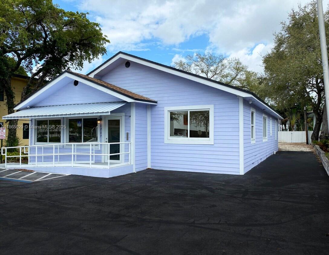 A rare Live/Work opportunity on East Broward Boulevard in the Victoria Park area of Fort Lauderdale. This 1,784 +/- free standing building has beautifully restored Dade County Pine finishes, an exposed ceiling, and has been updated throughout. As you enter the front door, there is a reception and work area along with a restroom. To the right of this area is a conference room with windows on two sides. Through a door off of the reception area, there are 4 rooms, all @ 13x13. There is a kitchenette with a dishwasher and full-size refrigerator/freezer, an ADA restroom, and a full bathroom with a shower. The back door leads to a fenced yard with a private deck. Behind the fenced yard is a large parking area which is accessible via the rear alley. This is ideal for someone wanting to occupy