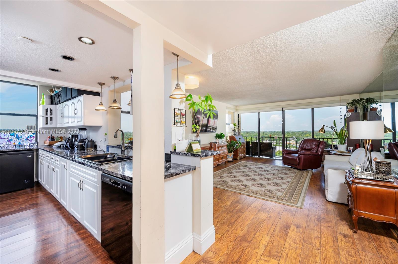 This large 2/2 corner unit has a wraparound balcony that boasts water and sunset views! Open concept layout, with the kitchen open to dining area and living room. Large sliding glass doors provide an expansive view to the West and flood the home with beautiful natural light. Primary bedroom has 2 walk in closets and en suite bathroom. Large pantry / storage closet adjacent to kitchen and entry foyer. Unit comes with 3 parking spaces. WELCOME HOME!