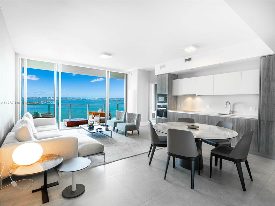 Experience luxury living in this beautifully designed 2-bed, 2.5-bath condo at Biscayne Beach in the heart of Edgewater.  Beautifully designed with elegant wallpaper throughout, this unit is sold fully furnished with designer furniture and finishes. Enjoy breathtaking direct Bay views from your spacious balcony with access from living space and primary bedroom. Features include custom cabinetry in each walk-in closet and bar area, a private elevator foyer entrance, and 2 assigned parking spaces. Biscayne Beach offers resort-style amenities including, two pool decks, resident BBQs, tennis courts, beach volleyball and entertainment area, gorgeous spa, fitness center, and more. Conveniently located near Design District, Wynwood, Miami Beach, and Brickell.