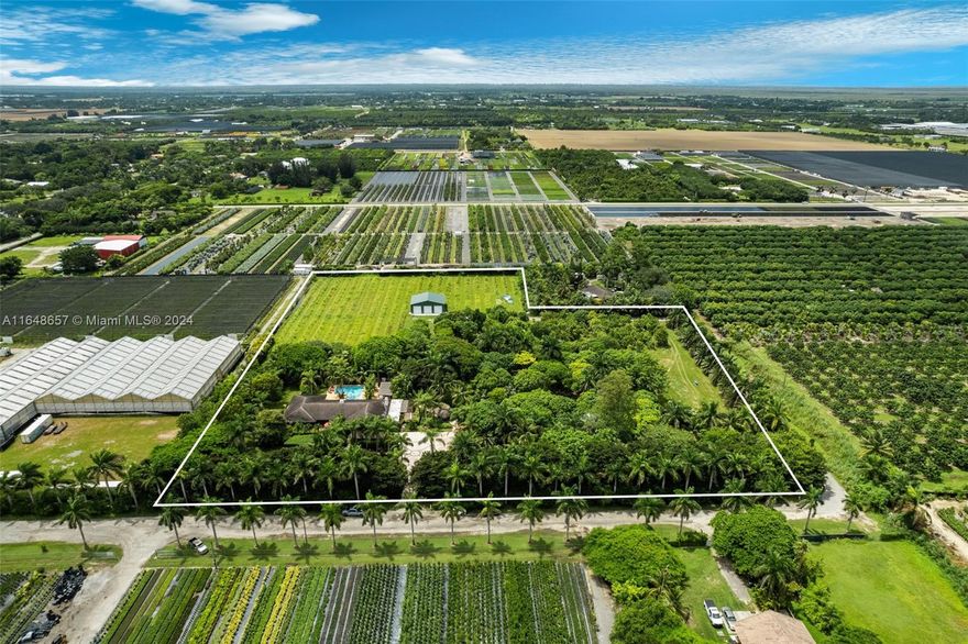 Experience serenity at this 7-acre Redland Estate! This hacienda-style, single story ranch features 4 bedrooms and over 3,700 SF living area in your own private oasis. Features including a formal dining room, living room, bar room, office, kitchen and laundry room. The property boasts a resort-style pool, custom hot tub with cold plunge pool and new poolside outdoor kitchen. Paver walkways lead to a fire pit, second outdoor kitchen, chickees surrounded by lush tropical landscaping and a fruit tree grove. A newly constructed steel warehouse spanning 50X40 feet with 3 spacious bay doors. Fenced and private, and just three miles from the Redland Golf & Country Club.