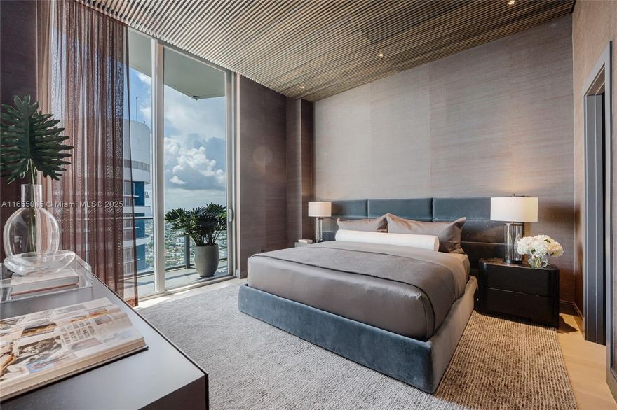 TROPHY PENTHOUSE   never-lived-in, professionally designed and FULLY furnished, where every detail exudes sophistication. At the heart of the home, a breathtaking Timothy Oulton suspended Natural Rock Crystal chandelier creates a dazzling focal point. Walls finished in American clay not only add an organic elegance but also naturally regulate humidity, while suspended slat wood 11 ft high ceilings and cutting-edge Radio RA3 smart lighting enhance the ambiance.
Indulge in bespoke features, including a state-of-the-art Anima Domus custom bed and a smart steam aromatherapy shower for a spa-like retreat. A stunning Philipp Jeffries mural, onyx sconces, and custom cabinetry throughout provide both style and functionality. 2 parking spaces included! NO EXPENSE SPARE!