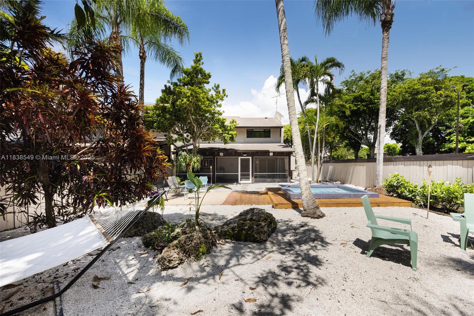 A private Key West-style retreat nestled behind lush foliage in The Falls Townhouses. This fully updated 2BD/3BA two-story residence offers a bright open-concept layout with a modern kitchen, vaulted 11’ ceilings in the primary suite, and tastefully renovated baths. Enjoy seamless indoor-outdoor living with a spacious screened Florida room and a tropical backyard oasis featuring mature mango trees, coconut palms, and a plunge pool. Centrally located near The Falls, Publix, and Metrorail, yet tucked away for peace and privacy.