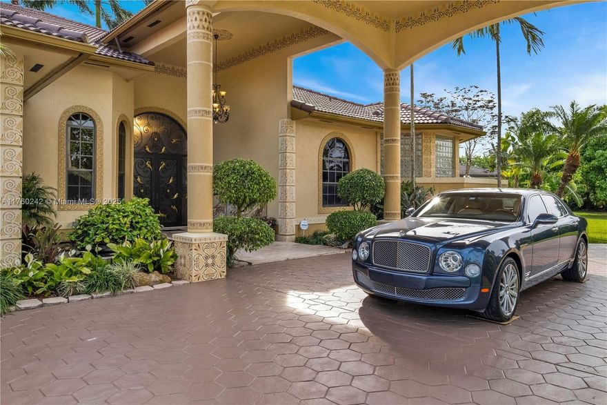 Discover a masterpiece in the Redlands! This exquisite estate features custom iron gates, a grand porte-cochere, and lush palm-lined landscaping. Inside, soaring ceilings, custom millwork, and hand-painted walls by a commissioned artist create a one-of-a-kind ambiance. Lavish window treatments, Birdseye Maple cabinetry, and opulent chandeliers, some 18K gold-plated, enhance its elegance. Offered fully furnished, this home boasts a screened lanai, lush gardens, and a sparkling pool—perfect for entertaining. A rare opportunity to own a true work of art!