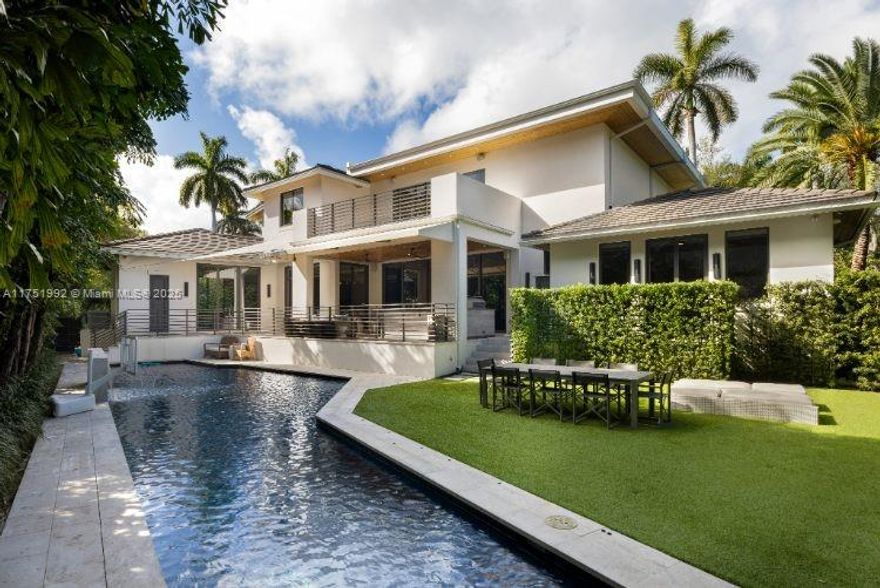 Contemporary residence on exclusive Sunset Island II blends modern elegance with tropical sophistication. This exquisitely furnished turn-key home w/ 7 beds+ media room+ office/ 6.5 baths is situated on an expansive & lushly landscaped 12,500 corner lot. Slide open oversized glass doors and entertain out on your covered outdoor living room with full outdoor kitchen. This private oasis w/elegant upgrades throughout boasts soaring ceilings, wide plank oak & natural stone flooring, luxurious bar & cocktail area & open chef’s kitchen w/ eat in area overlooking the sparkling 70 ft heated lap pool. Designed for ultimate relaxation, the spacious master suite features boutique style walk-in closet & marble/wood spa-like bathroom, completely renovated in 2023.