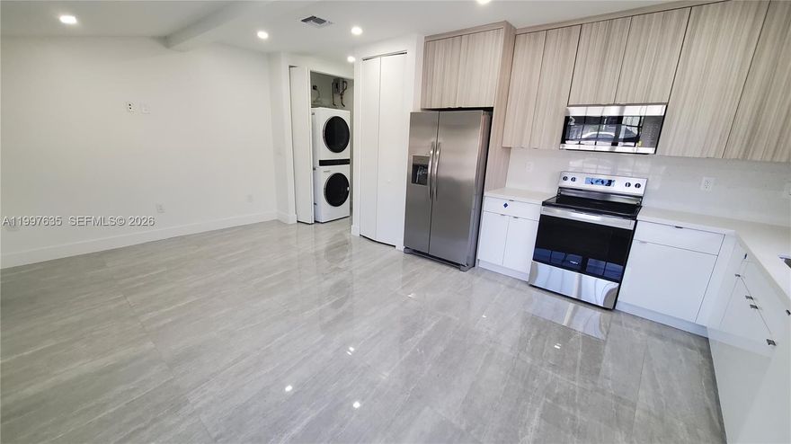 Be the 1st to live in this exquisitely renovated 3bed/2bath apartment (listing is for 1 unit out of the 3 total units in the Triplex property). Brand new roof, modern ceramic flooring, impact windows, high-end luxury appliances, LED lighting fixtures and modern bathrooms. Gorgeous modern design and freshly painted inside and out! 2 parking spaces. Owner spared no expense in this beautiful renovation.