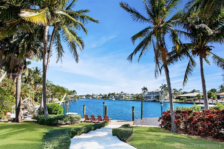 Enjoy an elevated vantage point atop Old Cutler Bay waterfront lot w/long, wide water views, snug harbor, prevailing breezes & exceptional privacy! Classic Miami Minimalist fully renovated in 2005. L-shaped footprint enhances pool/channel panoramas & affords dbl the outdoor covered living space w/morning sun/afternoon shade. Tiered patios hem seawall, wood dock & lift. Spacious interiors; marble & wood flrs. Gorgeous coffered living rm; formal dining rm; gourmet kitchen & adjoining family rm; game rm w/pool-access bath — all boast water views. En suite bdrms w/walk-ins; 2nd-flr Master suite crowns the resort-like sanctuary & commands ultimate water views. This handsome tropical estate embodies the SoFla waterfront lifestyle in highly desirable gated Old Cutler Bay.