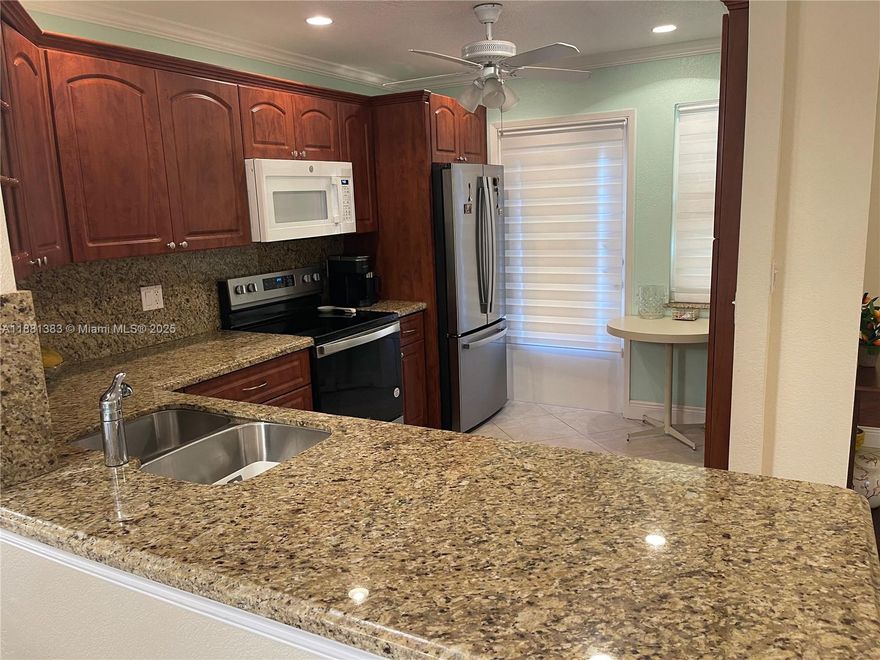Spacious apartment with renovated open style kitchen in a quiet 55+ co-op community. Enjoy tropical garden views from your screened in private balcony. Impact windows and sliding glass doors for your peace of mind. Huge primary bedroom with walk in closet and ensuite bathroom. Conveniently located near shopping, dining, houses of worship and minutes to the beach! Secured building with assigned covered parking and extra storage space. Low maintenance cost!