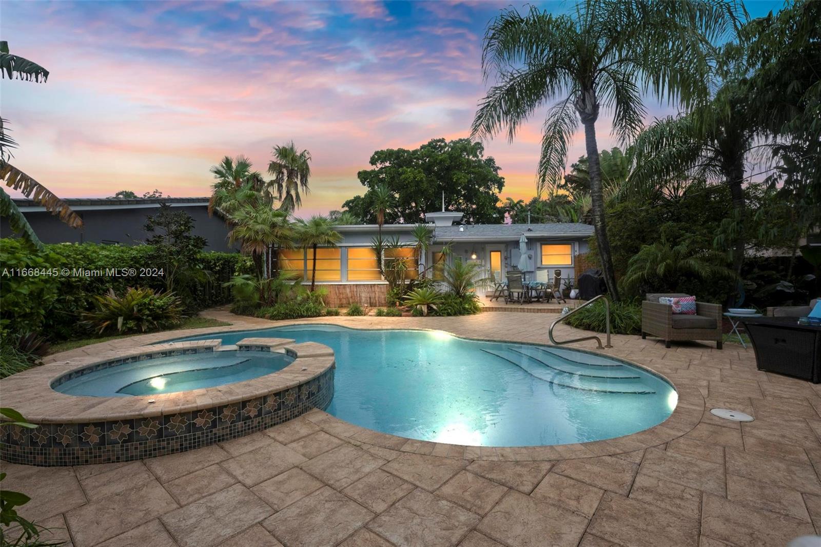Welcome to your tropical haven!This beautiful home combines style & comfort w/ its open floor plan, spacious living areas, & abundant natural light. The kitchen boasts sleek granite countertops, stainless steel appliances, The cozy, carpeted bedrooms offer a peaceful retreat for restful nights. Escape to your private oasis featuring a freeform pool, built-in spa, and waterfall, all set against lush tropical landscaping with lighting. Relax in your own private resort. Home features New Roof and New Water heater, accordion shutters. Truly a move-in ready home. Walking distance to popular restaurants, shops, & local hospitals, short drive to the beach It's the perfect neighborhood for biking or walking your dogs.