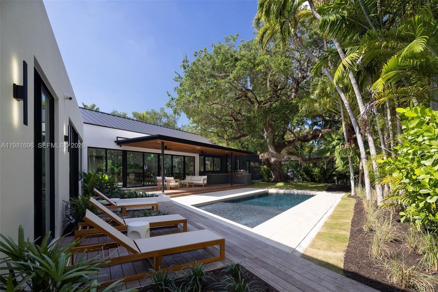 Introducing Oak House, a stunning architectural showpiece on North Coconut Grove’s most sought-after street, Micanopy Avenue. Elevated above the floodplain, this residence blends timeless elegance with contemporary sophistication, offering seamless access to parks, the Grove, and downtown. Developed by Urbane Capital and Billskog Construction, it features Italian Pedini millwork, Sub-Zero appliances, and custom finishes throughout. Sunlit open-concept living areas with soaring ceilings flow effortlessly into a lush, private backyard retreat. Perfectly designed for seamless indoor-outdoor living, the grounds include a heated saline pool, summer kitchen, and a mature oak with a sweeping canopy that provides natural shade and character. Expansive yet intimate, the setting invites relaxed afternoons and entertaining amid Coconut Grove’s vibrant tropical landscape. Oak House presents a unique opportunity to experience a thoughtfully curated residence in one of the area’s most desirable enclaves.