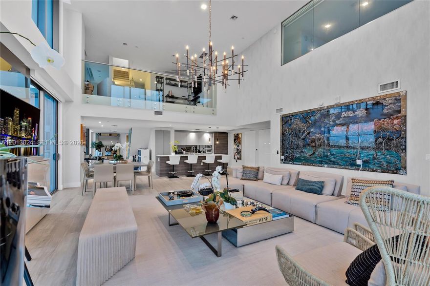 Triplex Penthouse in Midtown Miami's Hyde Residences. Featuring 4 beds, 4.5 baths with panoramic city views, PH3217 includes 3 parking spaces: 2 deeded spots located side-by-side, plus 1 valet parking space and 2 PRIVATE STORAGE ROOMS. Property features an impressive abundance of natural light streaming in through its expansive two-story, ground-to-ceiling windows, offering stunning skyline views at night. The 1st floor includes 2 luxurious en-suite bedrooms, a chef's kitchen, and a powder room. The 3rd floor ROOFTOP RETREAT hosts a SKY KITCHEN and its very-own PRIVATE JACUZZI, perfect for relaxation & entertainment.