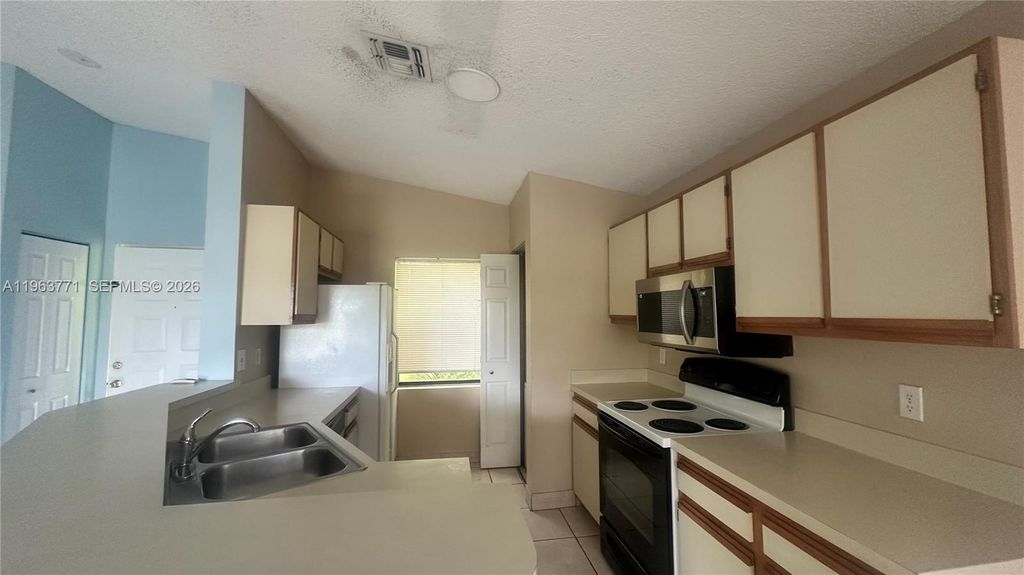 Photo of 9999 Summerbreeze Dr #315, Sunrise, FL 33322 (MLS # A11963771)